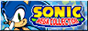 A small rectangular button with the logo for Sonic Mega Collection on the right. A picture of Modern Sonic smiling at the viewer can be seen on the right. The background is a light blue with the Sonic title screen emblem just barely visible.